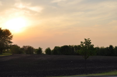 Sun setting on a farmers freshly planted field