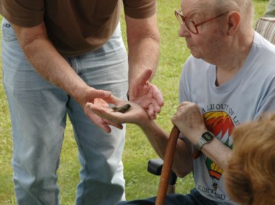 Sing holds a hummingbird in his hand