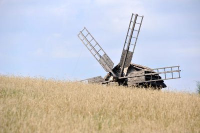 Windmill from the village of Vilshan behind a grassy slope, Pyrohiv
