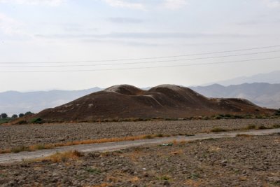 A dirt mound - ruins of an ancient structure along the Silk Road, Anau, Turkmenistan