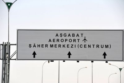 Road sign for Ashgabat Airport and the City Center