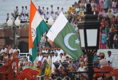 The flags of India and Pakistan cross as they are lowered at the end of the day