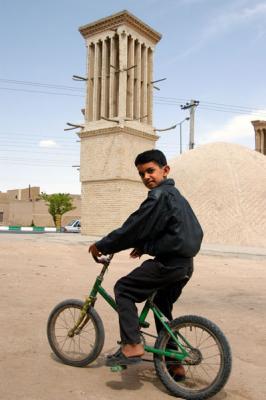 Iranian boy on his bike with a Badgir (windtower)