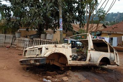 Wrecked and stripped car abandoned on Hoima Road, Kampala