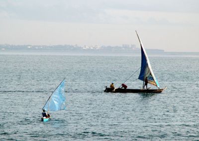 Tiny 1-man sailboat and a larger sailboat off Dar es Salaam