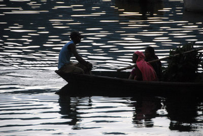 Man paddling a canoe on Lake Phewa, Pokhara