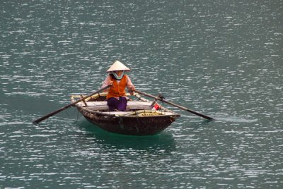 Old woman rowing a boat, Halong Bay