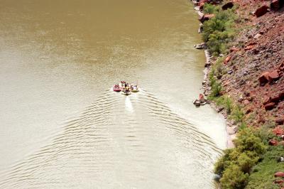 Inflatable rafts headed downstream with the current