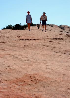 People descending from the upper precipice