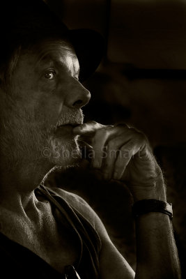 Pensive man on ferry in mono