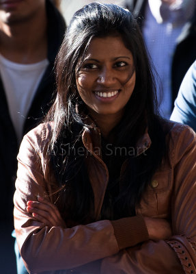 Pretty Indian girl (very copped) watching busker