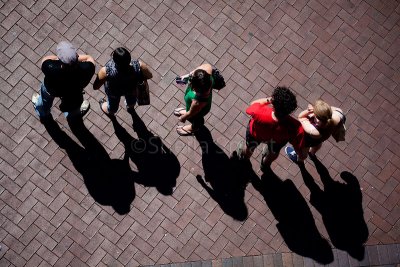 Shadows of people watching buskers