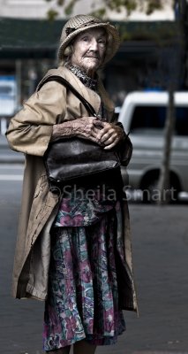 Very elderly lady clutching her bag