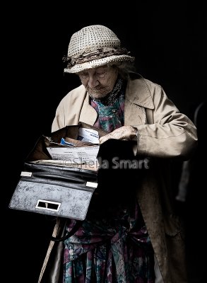 Very elderly lady looking into bag