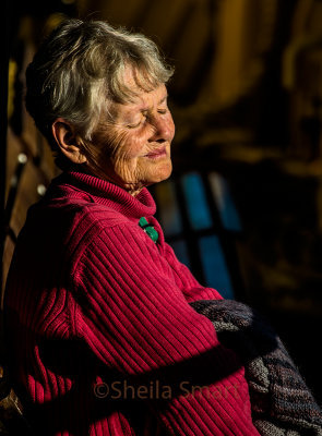 Lady making the most of winter sunshine on ferry