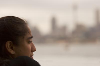 Girl on ferry with city backdrop bokeh