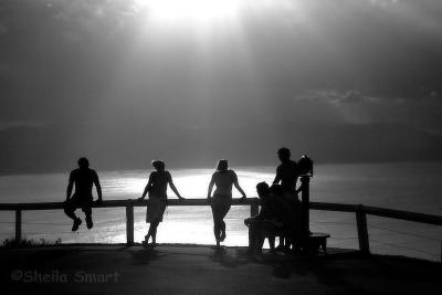 Group in silhouette Byron lighthouse in mono