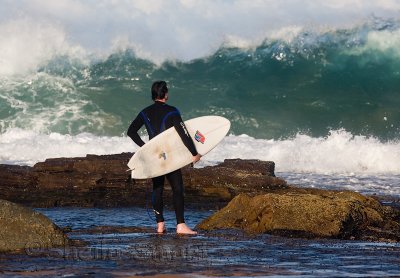 Surfer contemplating heavy surf