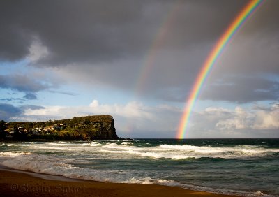 Late afternoon rainbow at Avalon Beach
