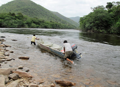 Theodore and Chris pull boat beyond rapids.