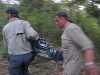 Tom and Marc carrying boat motor