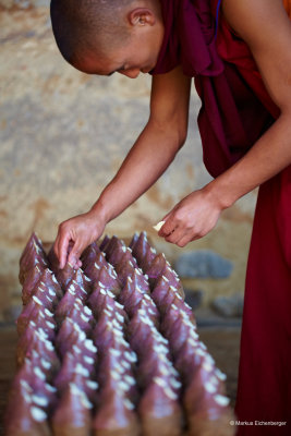 a monk preparing offerings