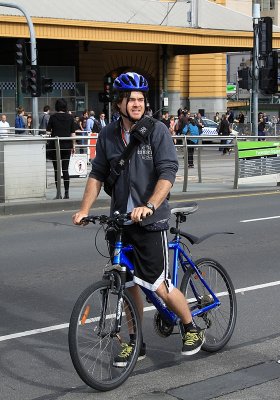 A biker stops to watch the models in Federation Square.