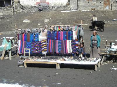 Tibetan's platform-shop near temple - see the locally found salagrama mUrthis on the left side baskets