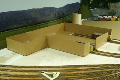 Cardboard mock-up in progress.   Note cars inside building.