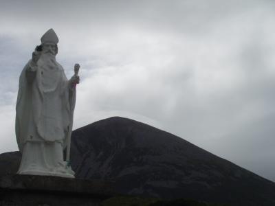 St Patrick in the foreground, the summit of Croagh Patrick in the background.  Approx 6 mi to the summit.