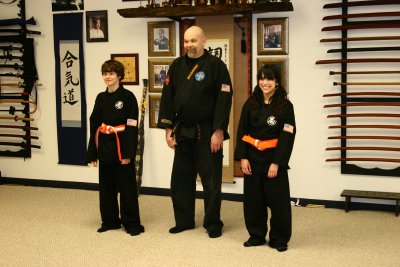 The two promotees with their new belts