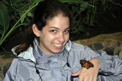 Monarch Butterfly on Samantha's Hand in the Butterfly Hatchery at the La Paz Waterfall Garden