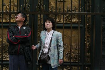 Tourists at Baptistery doors perusing the Duomo