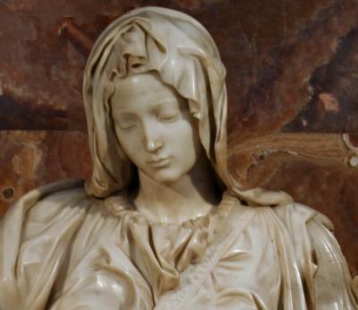 Michelangelo: a youthful Mary for mystery of birth and crucifixion.