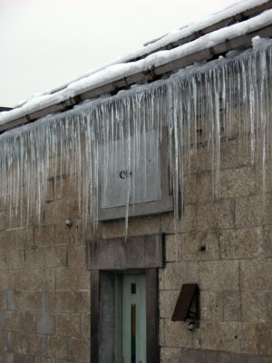 Icicles hanging off a stone kura