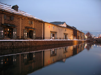 Illuminated warehouse facades along the canal