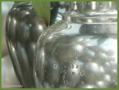 Reflection of silver balls on vases