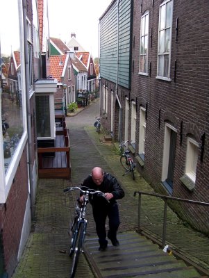Man pushes bike uphill