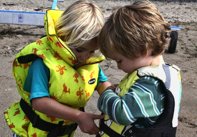 Chari helping take off Cooper's life-jacket