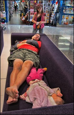Father and Child asleep at the Mall