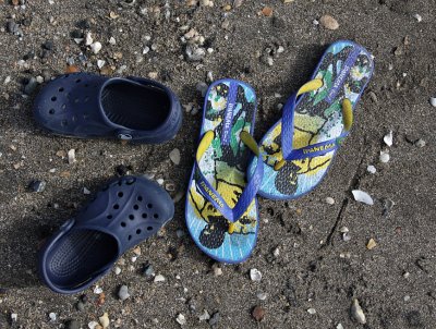 Crocs and jandals in the sand