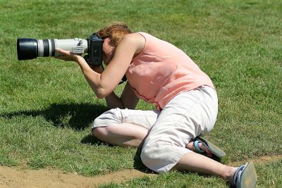 Char trying to take pics between the 1st base coaches legs