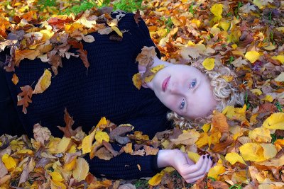 Lying in autumn leaves