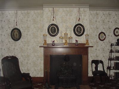 Notice the way portraits were hung and the fireplace seems to be a form of a stove.