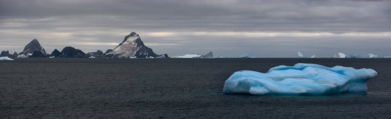 Blue iceberg in antarctic waters