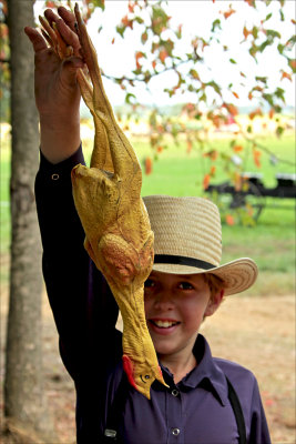 Amish boy with rubber chicken.
