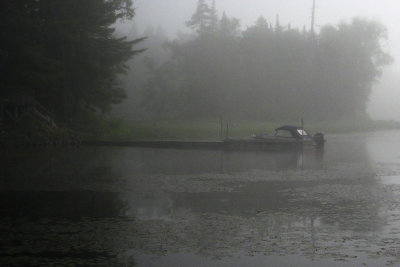 a boat waits out the  fog