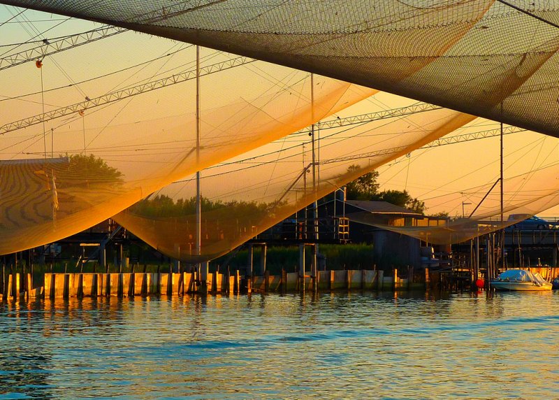 Huts and fishing nets at sunset