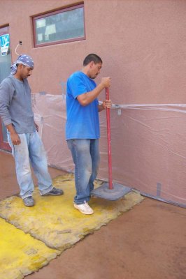 Stamping the wet concrete