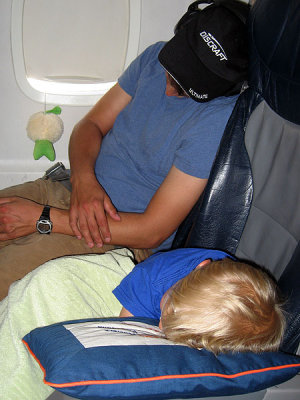 Simon, Daddy and Baby sacked out on plane to FL
